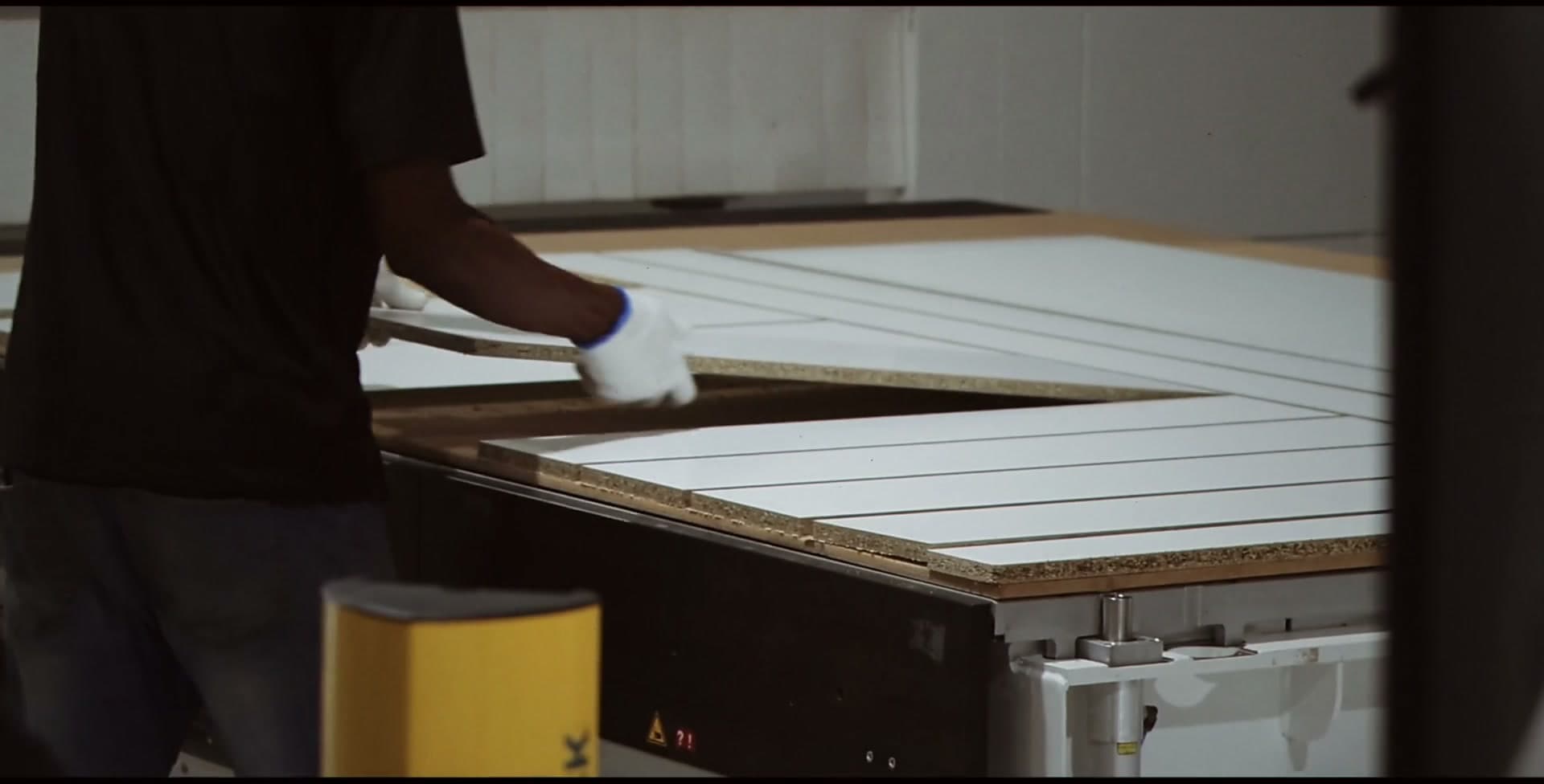 Cut panels being fed through the machine bed